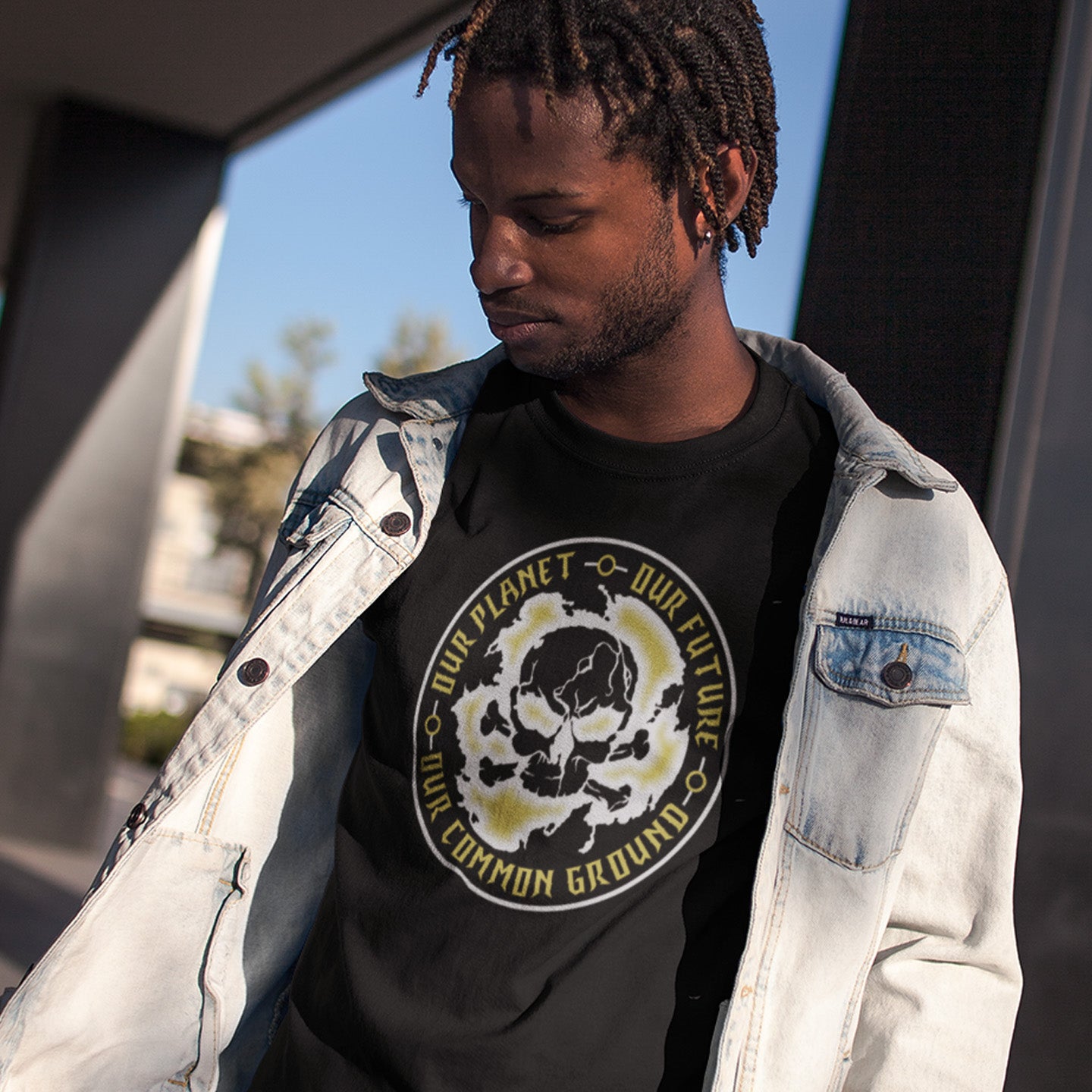 Person wearing a black t-shirt with a graphic design and text, standing outdoors. A save the planet t shirt for nature lovers who have environmental concern. Planet welfare should be something we can all agree on. Made from 100% organic ring-spun cotton, this save the Earth t shirt is unisex, high-quality, super comfy, and best of all, eco-friendly. Grey design.