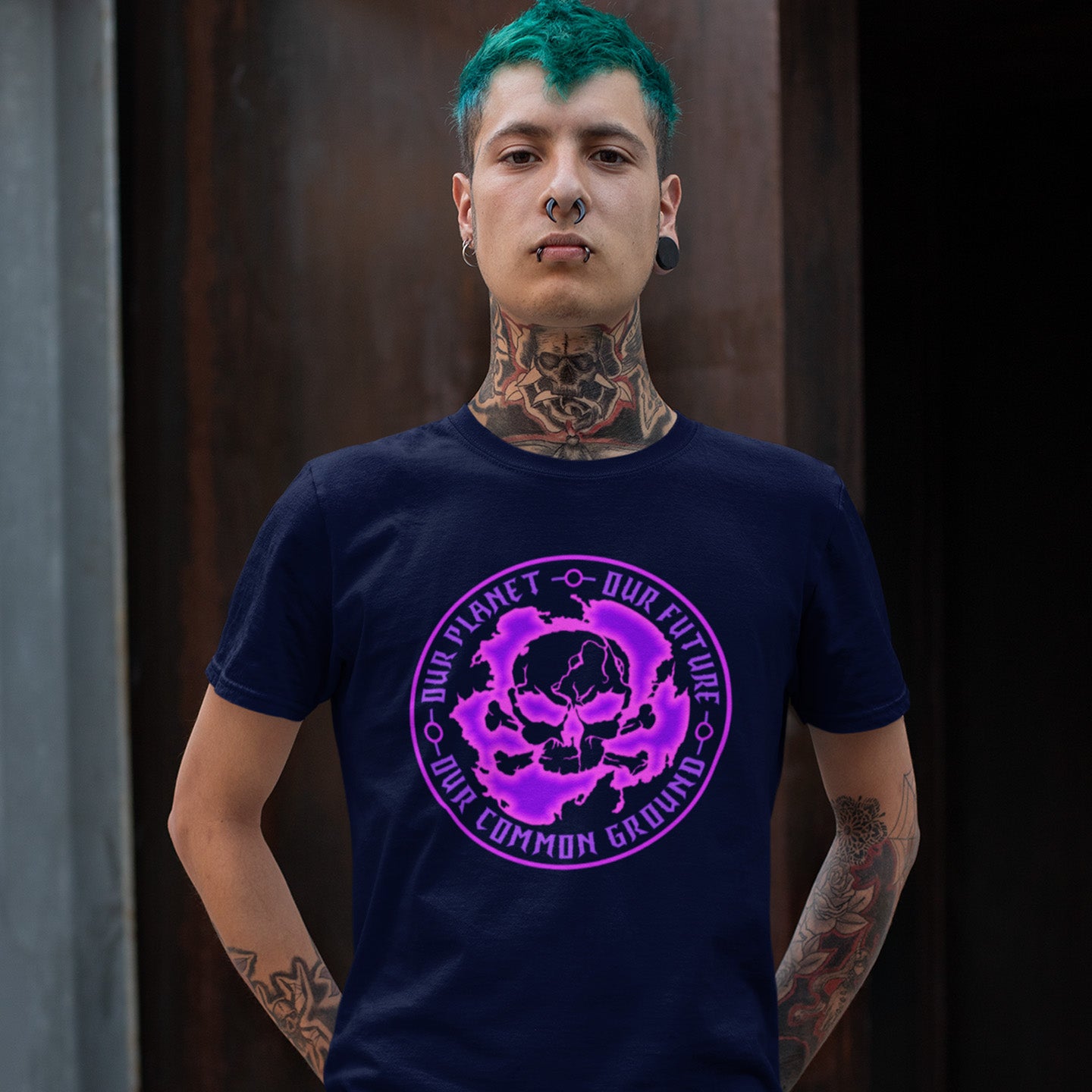 Person wearing a French navy blue t-shirt with a purple graphic design on a dark background. A save the planet t shirt for nature lovers who have environmental concern. Planet welfare should be something we can all agree on. Made from 100% organic ring-spun cotton, this save the Earth t shirt is unisex, high-quality, super comfy, and best of all, eco-friendly. Pink design.