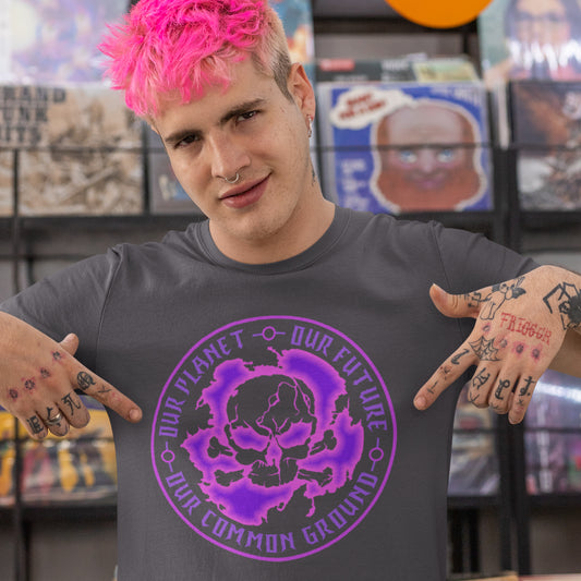 Person wearing a gray t-shirt with a purple skull design and text in a store setting. An environmental concern t-shirt for nature lovers who want to save the planet. Planet welfare should be something we can all agree on. Made from 100% organic ring-spun cotton, this climate concern t-shirt is unisex, high-quality, super comfy, and best of all, eco-friendly.