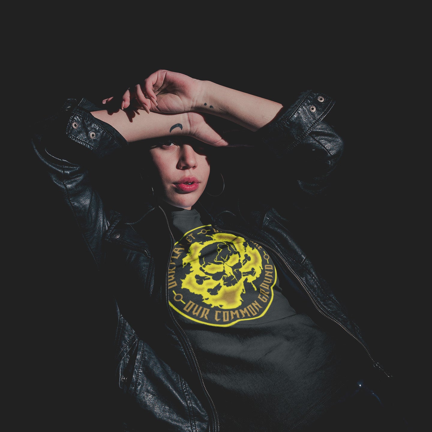 Person wearing a black leather jacket with a yellow graphic design on a dark background. An environmental concern t-shirt for nature lovers who want to save the planet. Planet welfare should be something we can all agree on. Made from 100% organic ring-spun cotton, this climate concern t-shirt is unisex, high-quality, super comfy, and best of all, eco-friendly. yellow design.