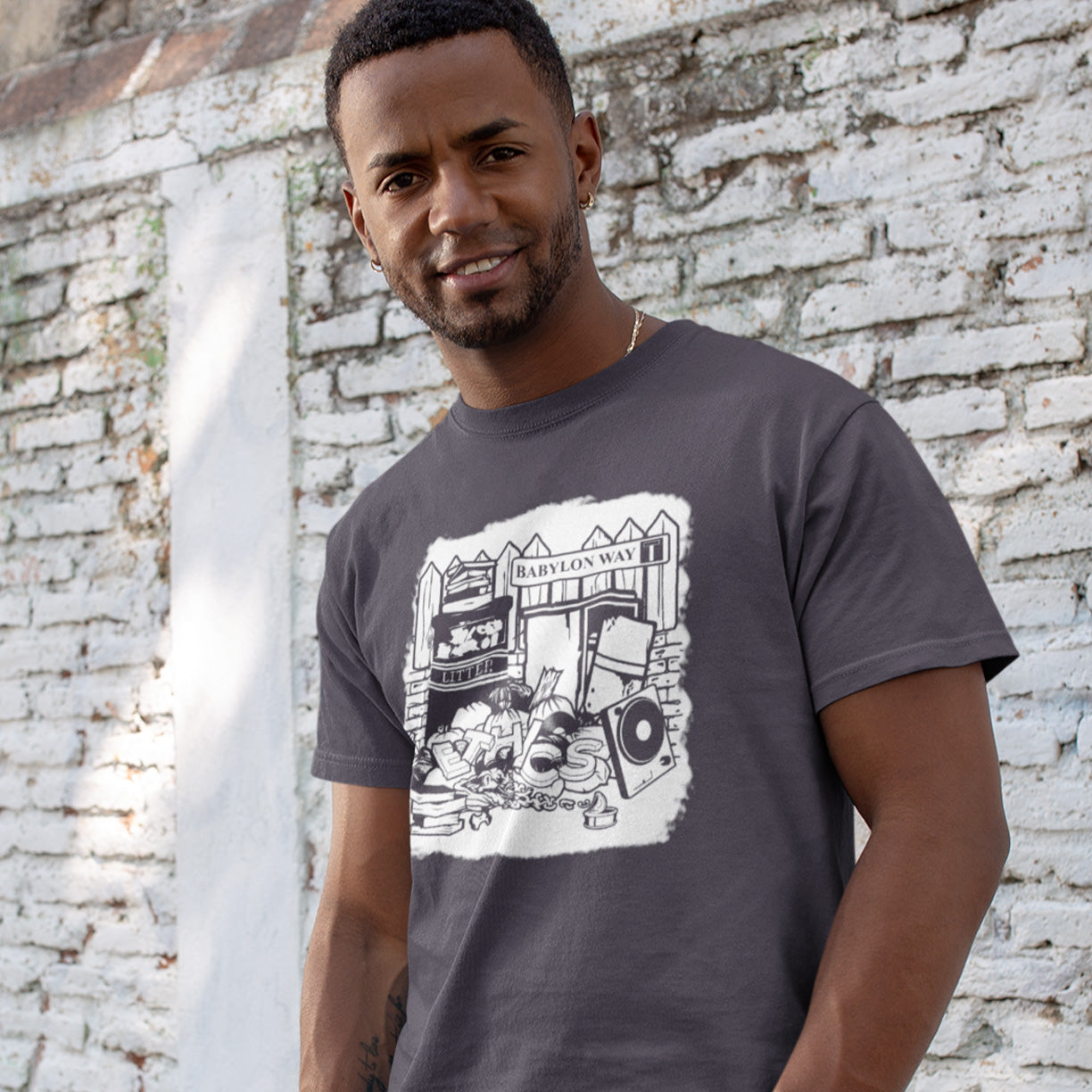 Man wearing an anthracite t-shirt with a graphic design in front of a white brick wall. A stencil art t-shirt depicting the end of integrity. There doesn't seem to be a place for ethics anymore in this mercenary world of money worship. It's amazing what people throw out these days. This unique street Art design depicts a sign of the times. Made from 100% organic ring-spun cotton, this social awareness t-shirt is unisex, high-quality, super comfy, and best of all, eco-friendly.