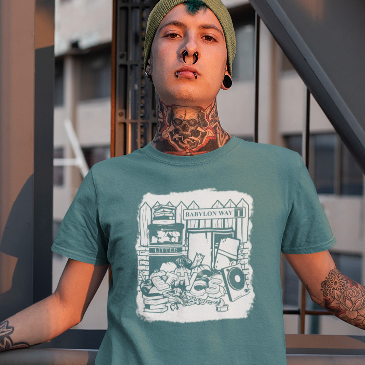 Person wearing a stargazer t-shirt with a graphic design, standing outdoors. A stencil art t-shirt depicting the end of integrity. There doesn't seem to be a place for ethics anymore in this mercenary world of money worship. It's amazing what people throw out these days. This unique street Art design depicts a sign of the times. Made from 100% organic ring-spun cotton, this social awareness t-shirt is unisex, high-quality, super comfy, and best of all, eco-friendly.