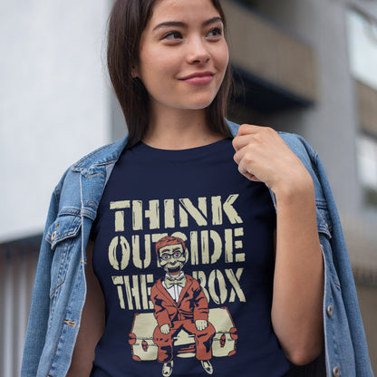 Woman wearing a French navy t shirt with 'Think outside the box' text. A think outside the box t shirt to promote diversity of thought. Trust the ventriloquist dummy to know thinking outside the box is liberating and progressive. Promote independent and creative thinking with this unique urban art design. Made from 100% organic ring-spun cotton, this counter culture t shirt is unisex, high quality, super comfy, and best of all, eco-friendly.
