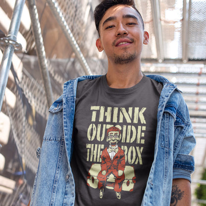Man standing outside wearing a 'think outside the box' t shirt. A think outside the box t shirt to promote diversity of thought. Trust the ventriloquist dummy to know thinking outside the box is liberating and progressive. Promote independent and creative thinking with this unique urban art design. Made from 100% organic ring-spun cotton, this counter culture t shirt is unisex, high quality, super comfy, and best of all, eco-friendly.