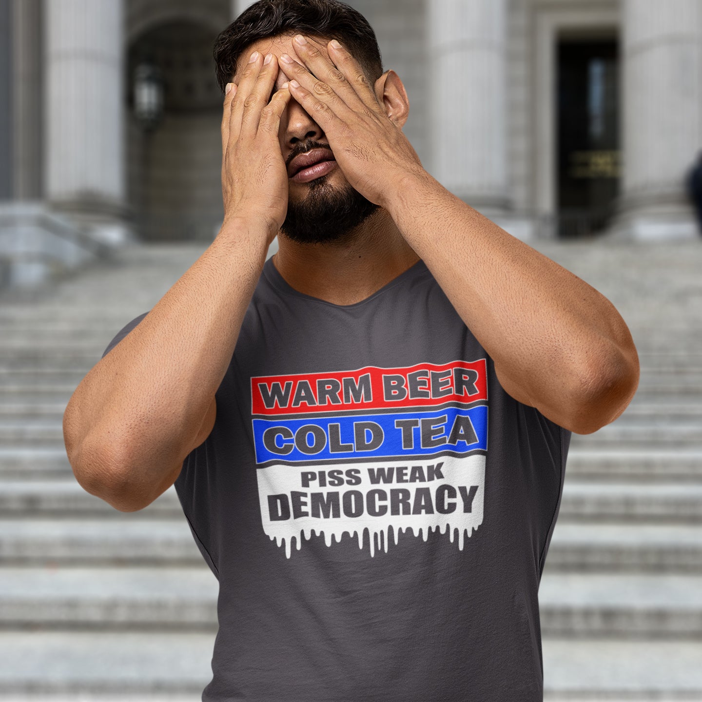 Man wearing a anthracite t-shirt with a political message in front of a building. This anti-establishment t-shirt comes with a short poem. Warm beer, cold tea, piss weak democracy. These are the things no one wants served to them !! this unique political t-shirt design is idea for any demonstration or protest rally. Made from 100% organic ring-spun cotton, this political anti government t-shirt is unisex, high-quality, super comfy, and best of all, eco-friendly.