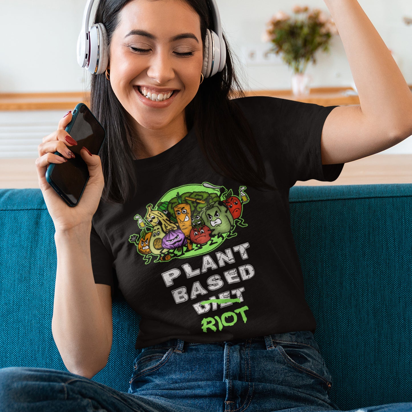 Woman wearing a black t-shirt with a plant-based diet graphic, sitting on a blue couch. A funny plant based dairy free t shirt design to highlight the speed at which people seem to be embracing a plant based diet. Welcome to the revolution ! Made from 100% organic ring-spun cotton, this funny meat free t shirt is unisex, high-quality, super comfy, and best of all, eco-friendly.