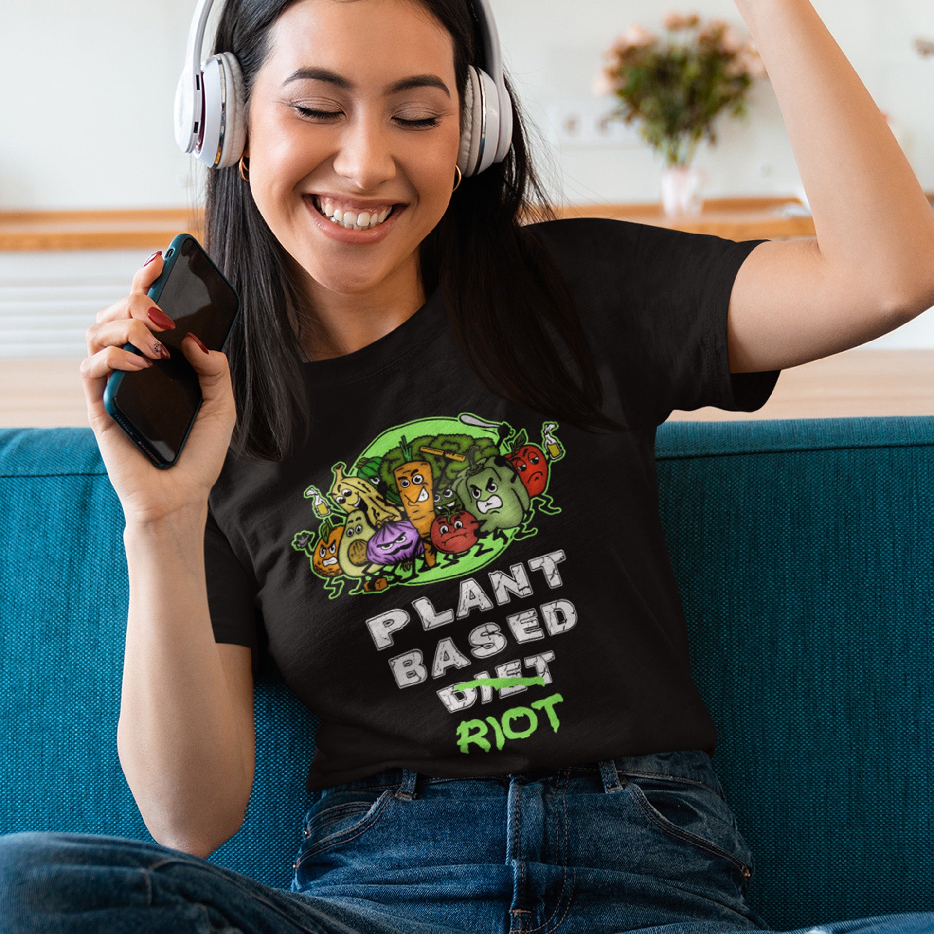 Woman wearing a black t-shirt with a plant-based diet graphic, sitting on a blue couch. A funny plant based dairy free t shirt design to highlight the speed at which people seem to be embracing a plant based diet. Welcome to the revolution ! Made from 100% organic ring-spun cotton, this funny meat free t shirt is unisex, high-quality, super comfy, and best of all, eco-friendly.