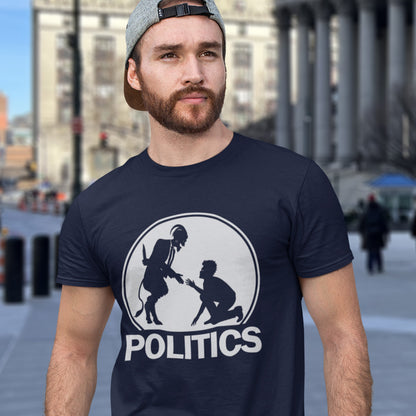 Man wearing a French navy blue t-shirt with a graphic design and the word 'POLITICS' on a city street. An anti government t shirt representing the simple inner workings of politics. Are they not stabbing the working class in the back to help the rich get richer ? Show your disapproval with this urban art t shirt. Made from 100% organic ring-spun cotton, this funny political t shirt is unisex, high-quality, super comfy, and best of all, eco-friendly.