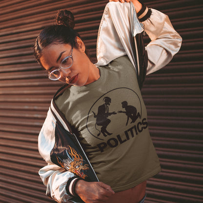 Person wearing a khaki t-shirt with a graphic design and text, standing against a corrugated metal background. An anti government t shirt representing the simple inner workings of politics. Are they not stabbing the working class in the back to help the rich get richer ? Show your disapproval with this urban art t shirt. Made from 100% organic ring-spun cotton, this funny political t shirt is unisex, high-quality, super comfy, and best of all, eco-friendly.