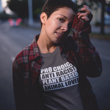 Person wearing a t-shirt with text on it, standing outdoors. A plant based meat free t shirt design intertwined with Pro Choice, Anti Racism, and Animal loving, characteristics that often go together. Made from 100% organic ring-spun cotton, this dairy free t shirt is unisex, high-quality, super comfy, and best of all, eco-friendly.