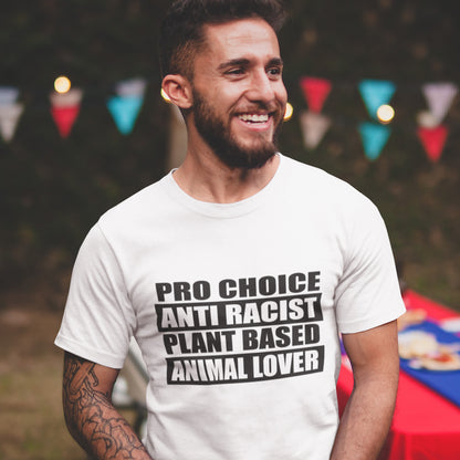 Man wearing a white t-shirt with pro-choice, anti-racist, plant-based, animal lover text at an outdoor event. A plant based meat free t shirt design intertwined with Pro Choice, Anti Racism, and Animal loving, characteristics that often go together. Made from 100% organic ring-spun cotton, this dairy free t shirt is unisex, high-quality, super comfy, and best of all, eco-friendly.