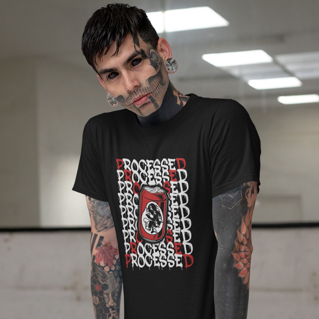 A heavily tattooed man standing in front of a mirror, wearing a black short sleeved crew neck t-shirt with a graphic of a baby in a soda can on the phone, surrounded by the text "PROCESSED" in white and red.