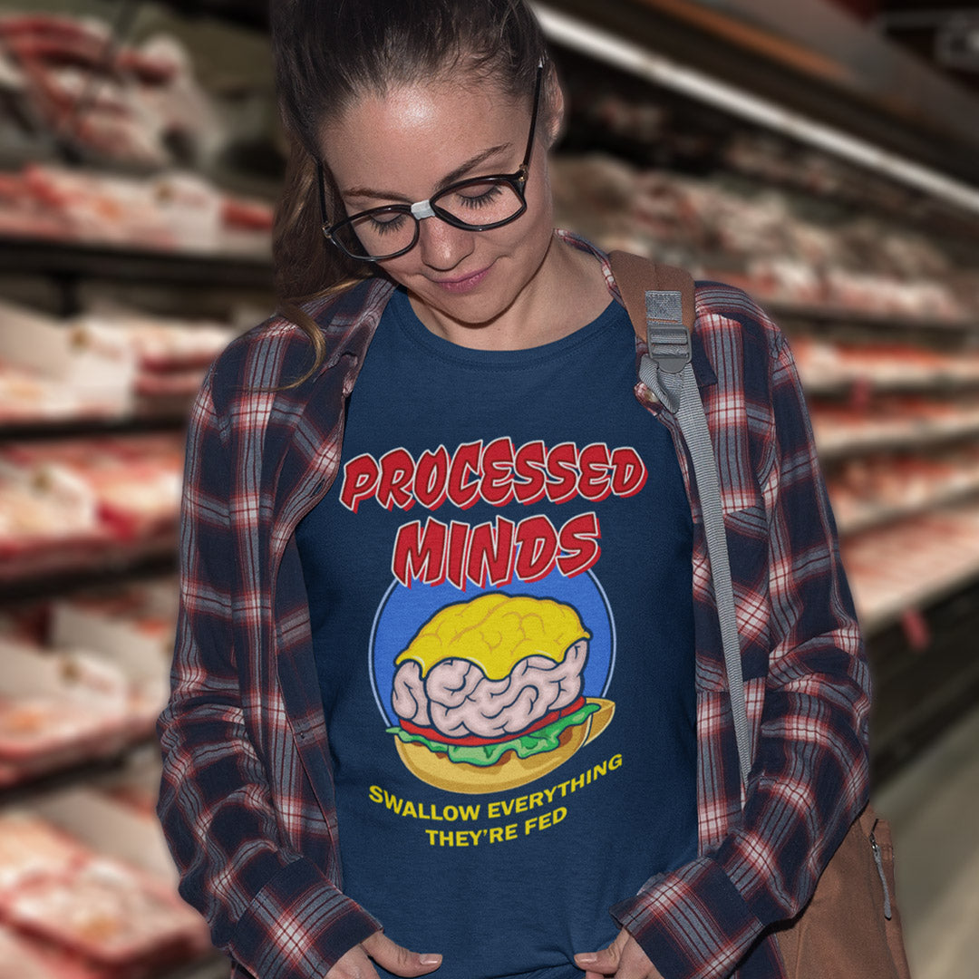 Girl in a supermarket wearing a 'Processed Minds' text t shirt. This sign of the times t shirt design represents the amount of influence and mental manipulation in circulation these days. Resist the brainwashing and bring back wild and organic independent thinking. Made from 100% organic ring-spun cotton, these social issues t shirts are unisex, high-quality, super comfy, and best of all, eco-friendly.