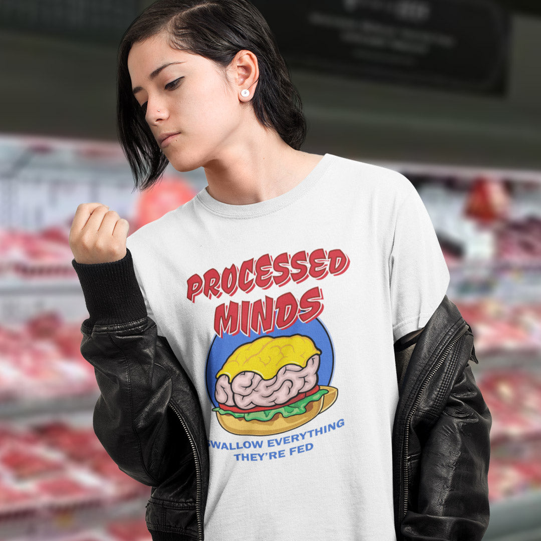 Girl stood in a bitcher shop wearing a white 'Processed Minds' t shirt. This sign of the times t shirt design represents the amount of influence and mental manipulation in circulation these days. Resist the brainwashing and bring back wild and organic independent thinking. Made from 100% organic ring-spun cotton, these social issues t shirts are unisex, high-quality, super comfy, and best of all, eco-friendly.