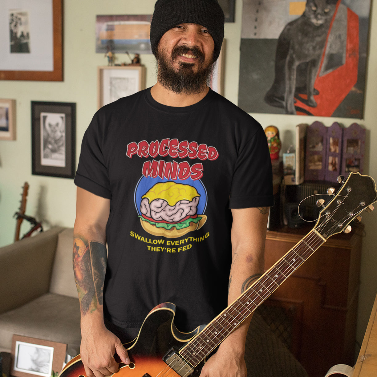 Man with guitar wearing 'processed minds' t-shirt. This counterculture design represents the amount of influence and mental manipulation in circulation these days. Resist the brainwashing and bring back wild and organic independent thinking. Made from 100% organic ring-spun cotton, this social awareness t-shirt is unisex, high-quality, super comfy, and best of all, eco-friendly.