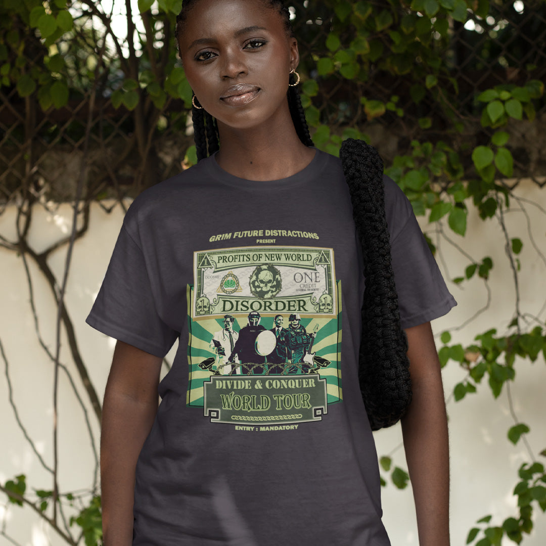 A woman standing in a street, wearing an anthracite grey t-shirt with a spoof world tour design of a band called "PROFITS OF NEW WORLD DISORER".
