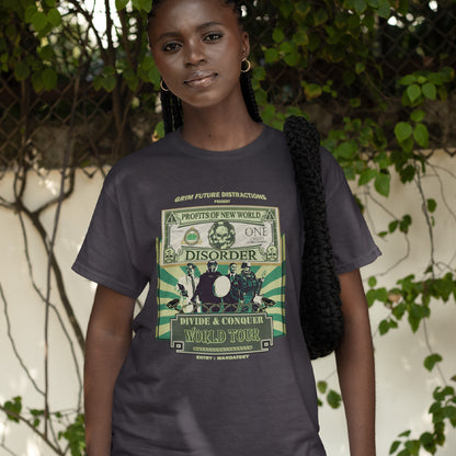 A woman standing in a street, wearing an anthracite grey t-shirt with a spoof world tour design of a band called "PROFITS OF NEW WORLD DISORER".