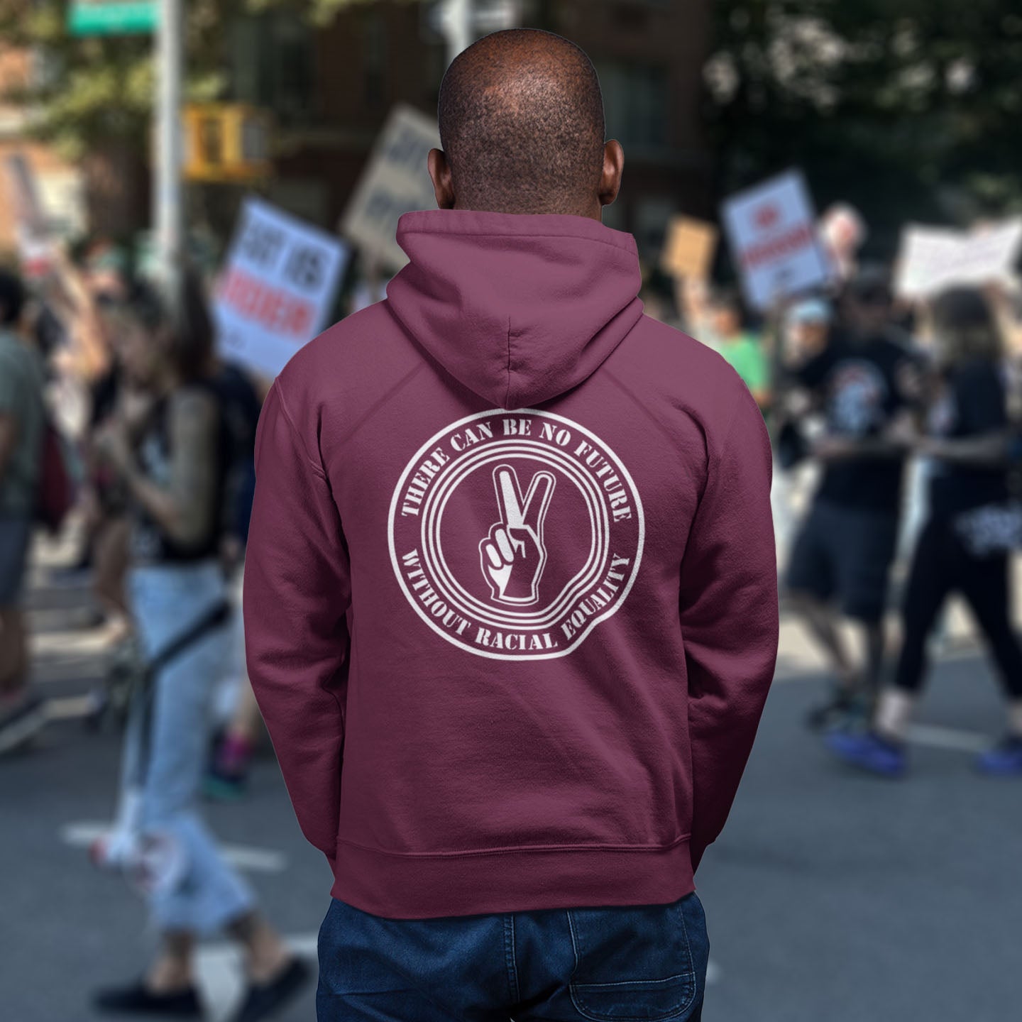 Person wearing a burgundy hoodie with a message at a protest rally. An anti-racism hoodie for Peace without prejudice There can be no future without racial equality. Comfortable and practical. It's extra soft and has a convenient front pouch pocket. Made from organic cotton and recycled polyester, this anti racism hoodie is a great eco-friendly choice.