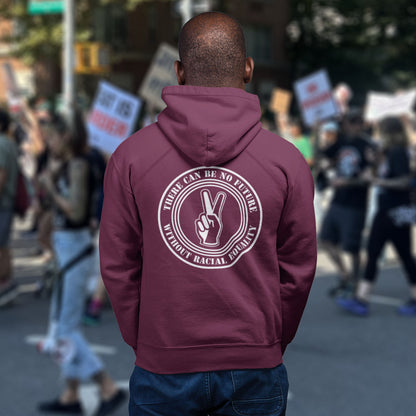 Person wearing a burgundy hoodie with a message at a protest rally. An anti-racism hoodie for Peace without prejudice There can be no future without racial equality. Comfortable and practical. It's extra soft and has a convenient front pouch pocket. Made from organic cotton and recycled polyester, this anti racism hoodie is a great eco-friendly choice.