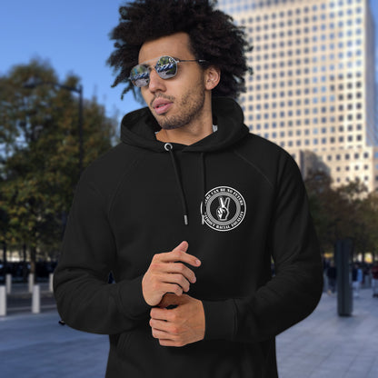 Man wearing a black hoodie with a logo in an urban setting. An anti-racism hoodie for Peace without prejudice There can be no future without racial equality. Comfortable and practical. It's extra soft and has a convenient front pouch pocket. Made from organic cotton and recycled polyester, this anti racism hoodie is a great eco-friendly choice.