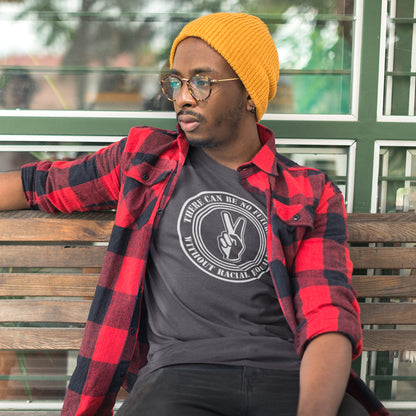 Man wearing a red plaid shirt, anthracite t-shirt with a graphic design, and yellow beanie sitting on a bench. An anti-racism t-shirt denouncing prejudice. Peace without prejudice. There can be no future without racial equality. Made from 100% organic ring-spun cotton, this social awareness anti racism t-shirt is unisex, high-quality, super comfy, and best of all, eco-friendly.