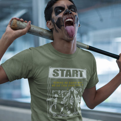 Person wearing a khaki t-shirt with 'START' graphic, holding a baseball bat indoors. This stencil graffiti t shirt represents the monotony of everyday working life. A unique satirical design for those times when life starts to feel a little repetitive, unnecessary, and questionable. Made from 100% organic ring-spun cotton, this urban art t shirt is unisex, high-quality, super comfy, and best of all, eco-friendly.