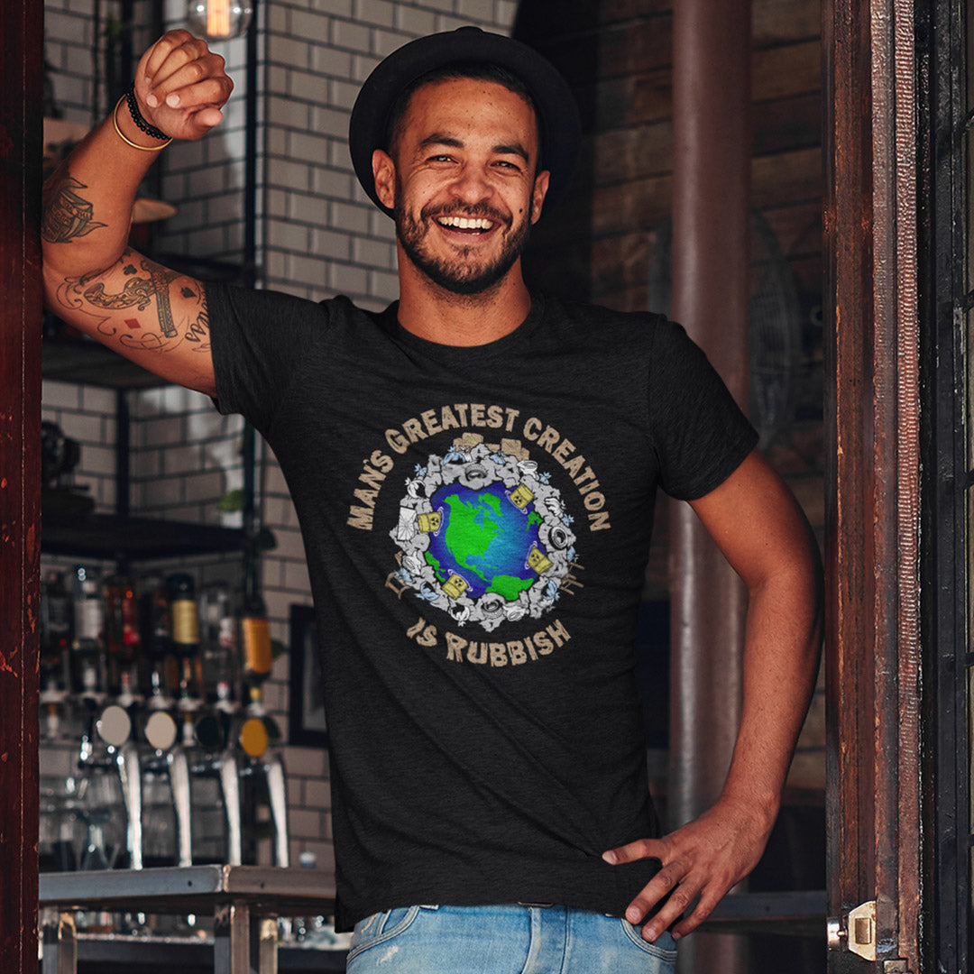Man wearing a black t-shirt with a graphic design and text, standing in a bar setting. A satirical save the planet t shirt design. If you really think about it the biggest creation man has added to the world is actually biproduct and trash. No wonder the planet is at risk of being poisoned. Made from 100% organic ring-spun cotton, this save the planet t shirt is unisex, high-quality, super comfy, and best of all, eco-friendly.