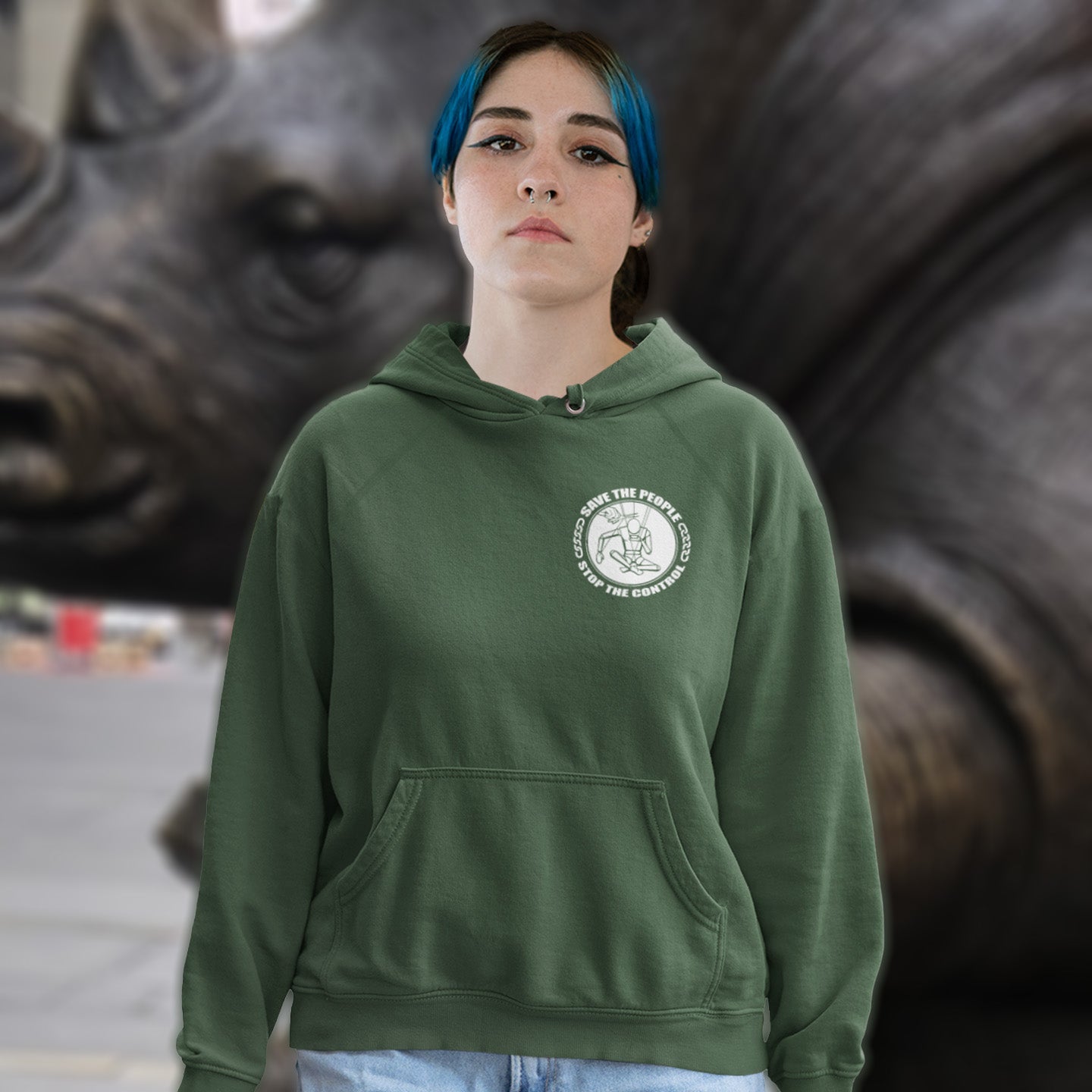 Person wearing a green hoodie with a logo in front of a rhinoceros statue. This political hoodie carries an anti-dictatorship message and encourages independent thought. A unique design promoting freedom of choice and a less controlling government. Comfortable and practical. It's extra soft and has a convenient front pouch pocket. Made from organic cotton and recycled polyester, this political hoodie is a great eco-friendly choice.