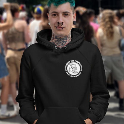 Person wearing a black hoodie with a logo in a crowded outdoor setting. This save the people hoodie carries an anti-dictatorship message and encourages independent thought and social awareness. A unique design promoting freedom of choice and a less controlling government. Comfortable and practical. It's extra soft and has a convenient front pouch pocket. Made from organic cotton and recycled polyester, this civil liberties hoodie is a great eco-friendly choice.