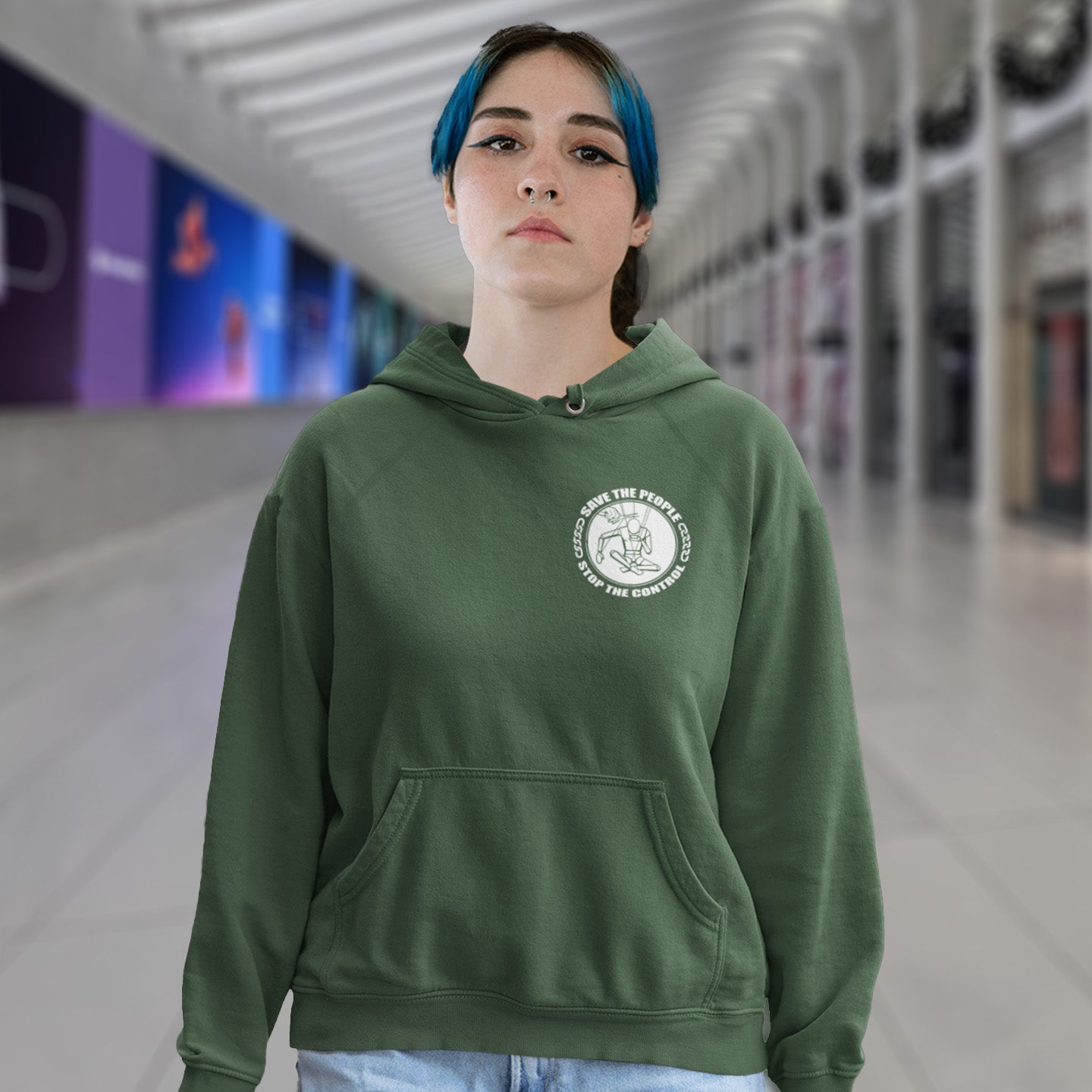 Person wearing a bottle green hoodie with a logo in an indoor setting. This save the people hoodie carries an anti-dictatorship message and encourages independent thought and social awareness. A unique design promoting freedom of choice and a less controlling government. Comfortable and practical. It's extra soft and has a convenient front pouch pocket. Made from organic cotton and recycled polyester, this civil liberties hoodie is a great eco-friendly choice.
