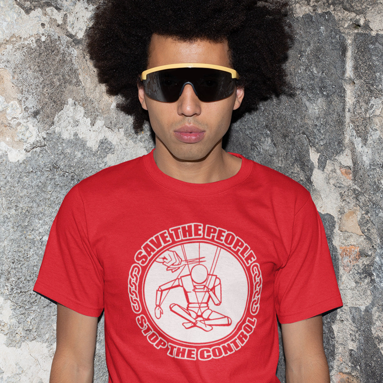 Person wearing a red t-shirt with a graphic design and text, standing against a textured wall. This civil rights t shirt carries an anti-dictatorship message and encourages independent thought and social awareness. A unique design promoting freedom of choice and a less controlling government. Made from 100% organic ring-spun cotton, this civil liberties t shirt is unisex, high-quality, super comfy, and best of all, eco-friendly.