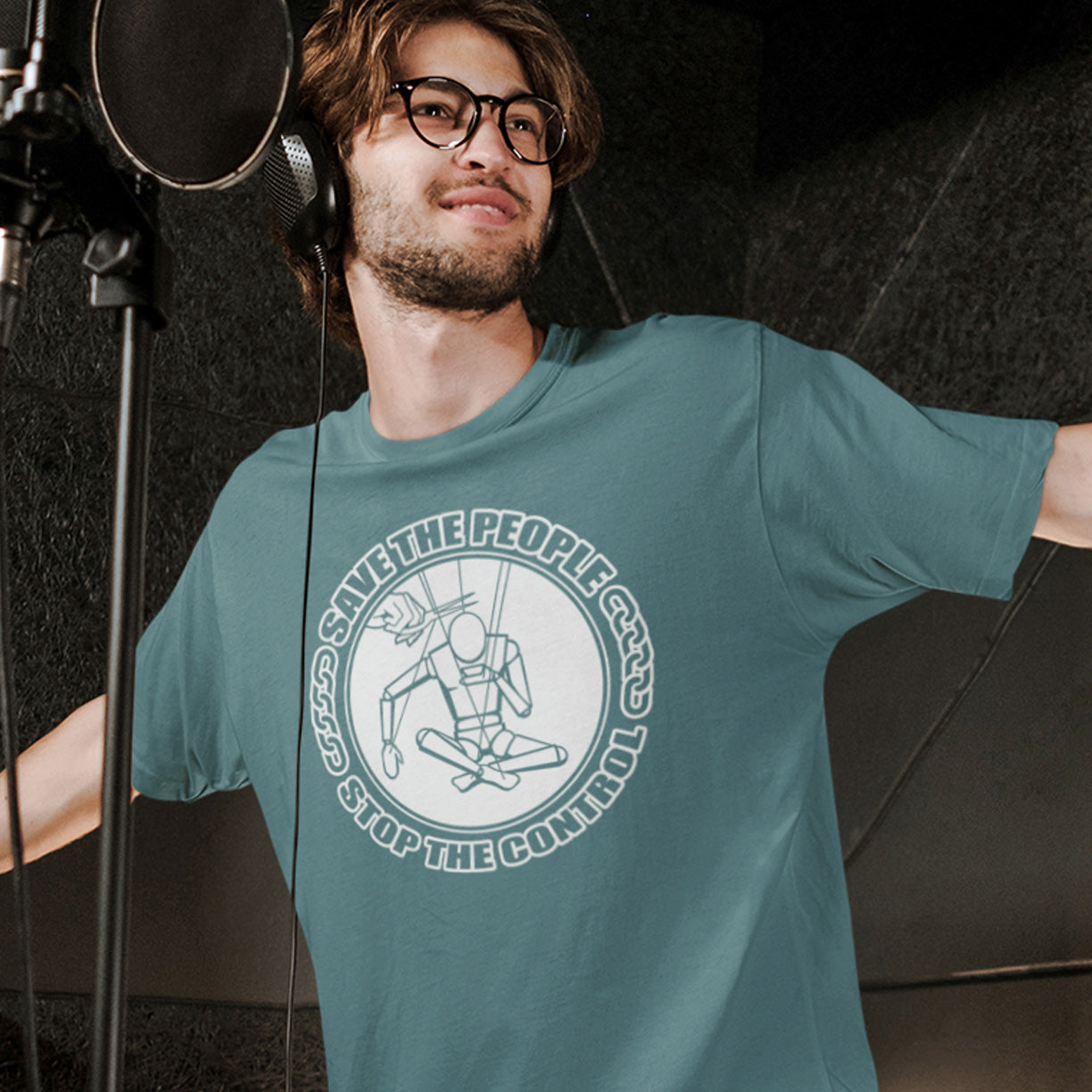 Man wearing a teal t-shirt with a graphic design in a studio setting. This civil rights t shirt carries an anti-dictatorship message and encourages independent thought and social awareness. A unique design promoting freedom of choice and a less controlling government. Made from 100% organic ring-spun cotton, this civil liberties t shirt is unisex, high-quality, super comfy, and best of all, eco-friendly.