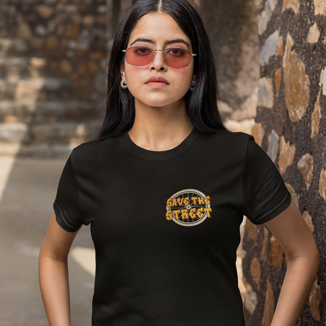 Woman in the street wearing a black t shirt. A street art t shirt design paying homage to street life. As our society increasingly turns to an online based community it's worth giving a shout out to where the real community is based, on the streets! Let's keep them full of life. Made from 100% organic ring-spun cotton, these street art t shirts are unisex, high quality, super comfy, and best of all, eco-friendly.