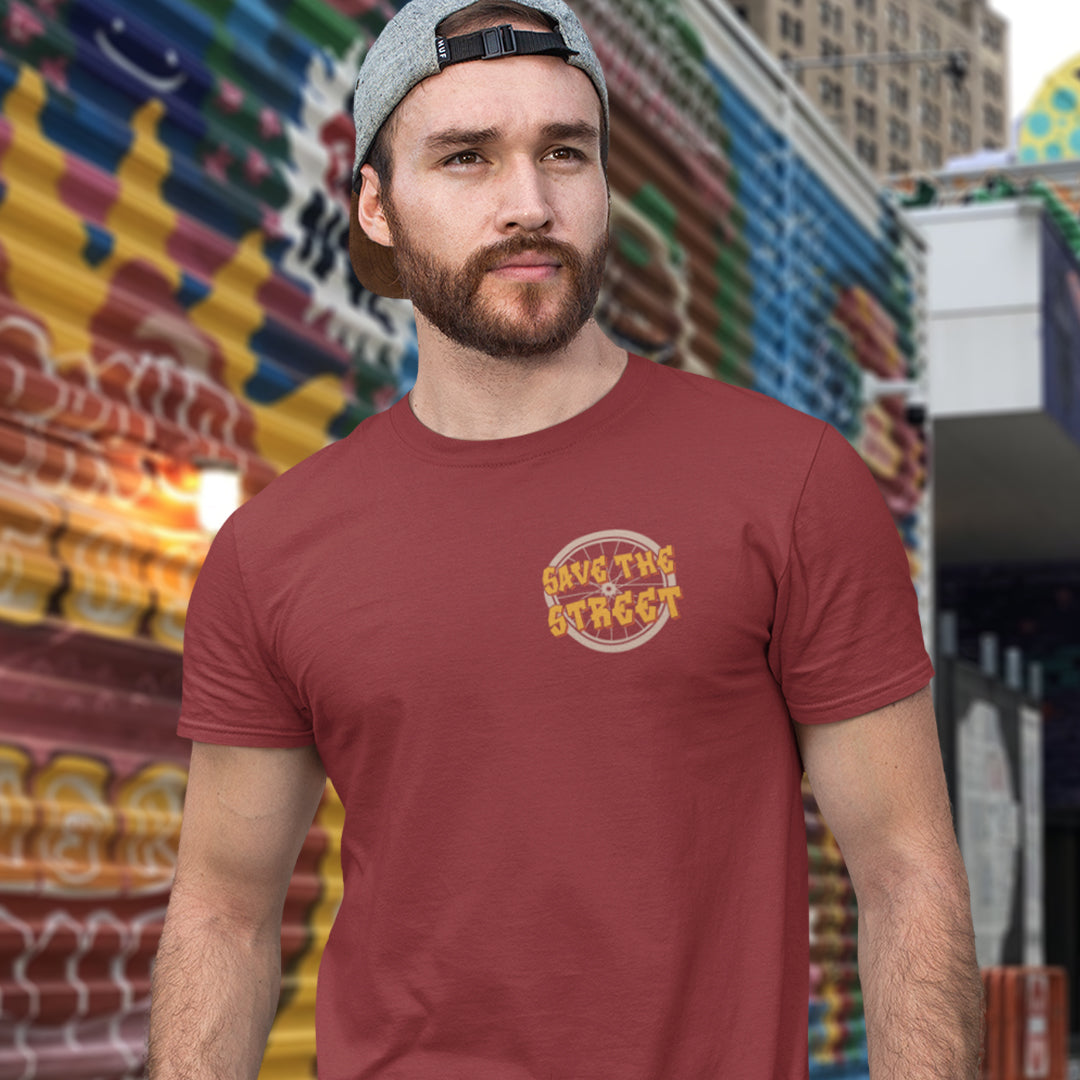 Man wearing a burgundy t-shirt with 'Save the Streets' logo in front of colourful street art. A street art t shirt design paying homage to street life. As our society increasingly turns to an online based community it's worth giving a shout out to where the real community is based, on the streets! Let's keep them full of life. Made from 100% organic ring-spun cotton, these street art t shirts are unisex, high quality, super comfy, and best of all, eco-friendly.