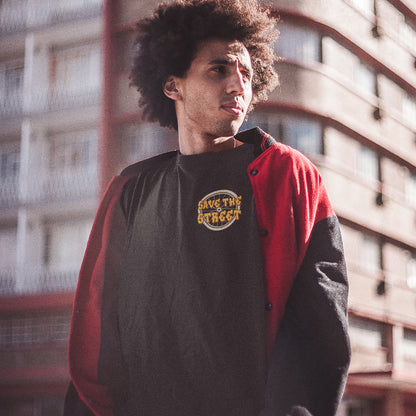 Person wearing a black and red jacket with 'Save the Street' logo. This street art t shirt stencil represents inner city street life as a culture of it's own. There is a ground level reality mixed with trustworthy honestly at street level in towns and cities across the planet that cannot be replicated by social media. Wherever you are in the world, may the street be with you. Made from 100% organic ring-spun cotton, this urban art t shirt is unisex, high-quality, super comfy, and best of all, eco-friendly.