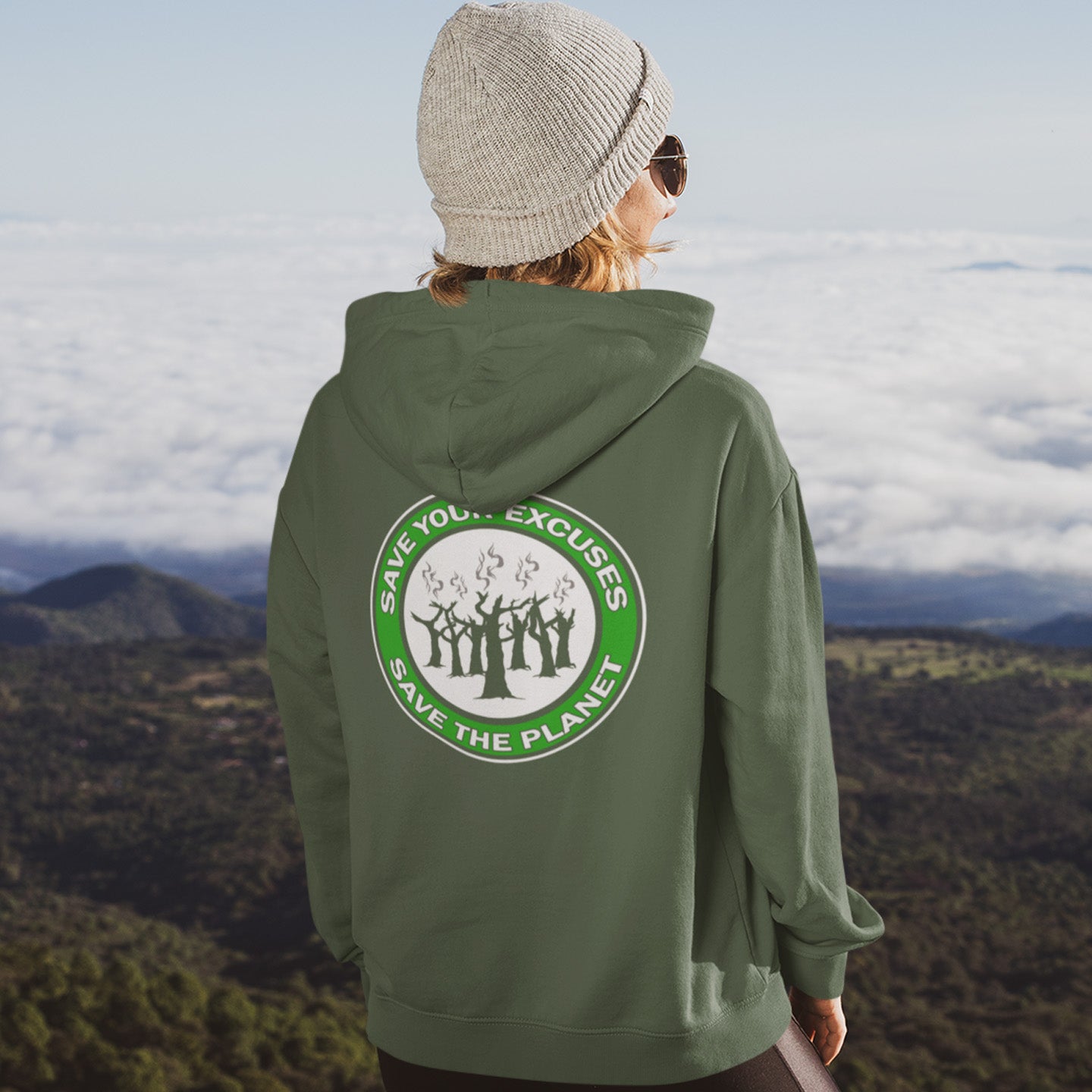 Person wearing a bottle green hoodie standing against a scenic mountain landscape. A save the planet t-shirt that promotes social awareness of environmental issues. It's time to stop making poor excuses for why we haven't got around to saving our planet yet. Comfortable and practical. It's extra soft and has a convenient front pouch pocket. Made from organic cotton and recycled polyester, this environmental awareness hoodie is a great eco-friendly choice.