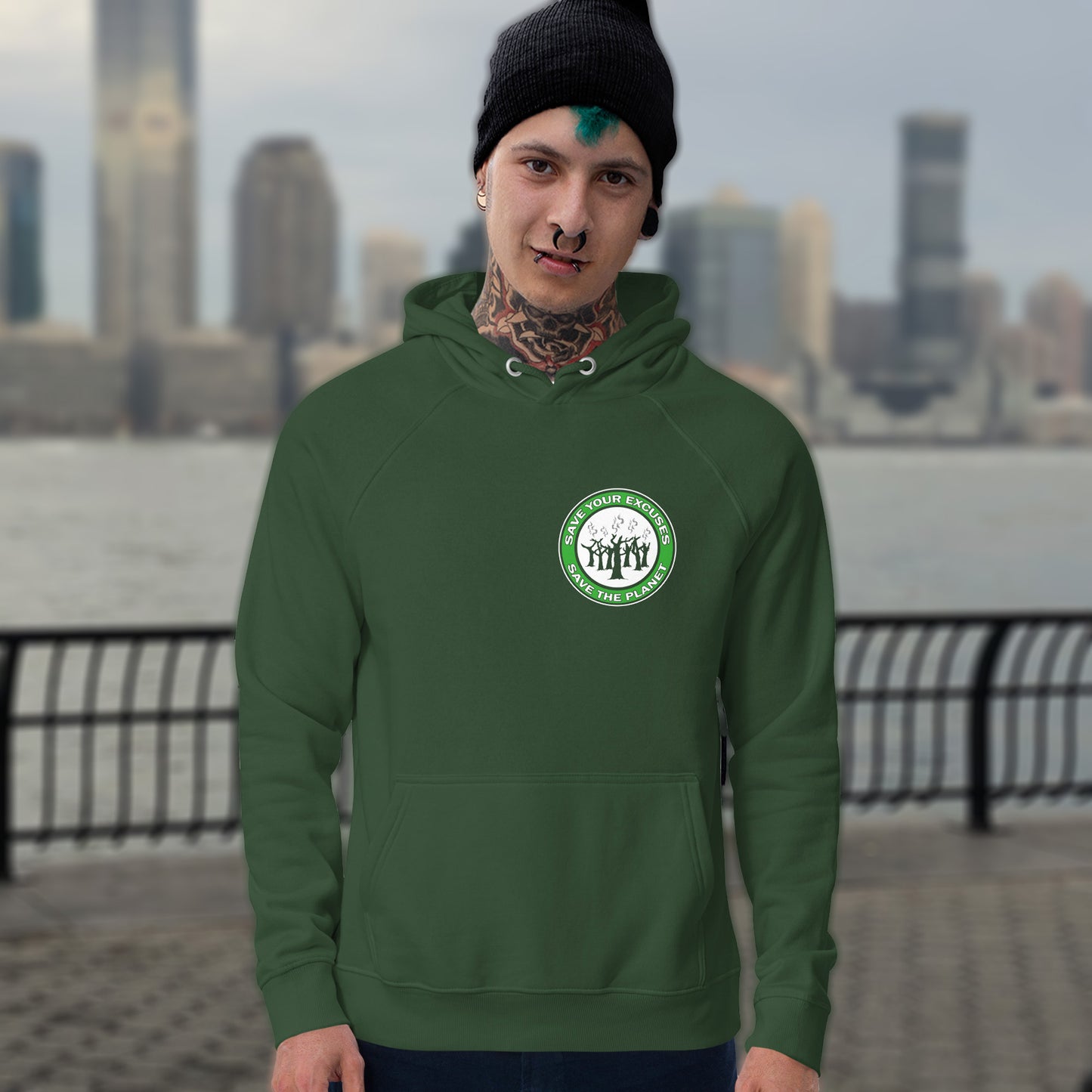 Person wearing a bottle green hoodie with a logo, standing in front of a city skyline. A save the planet t-shirt that promotes social awareness of environmental issues. It's time to stop making poor excuses for why we haven't got around to saving our planet yet. Comfortable and practical. It's extra soft and has a convenient front pouch pocket. Made from organic cotton and recycled polyester, this environmental awareness hoodie is a great eco-friendly choice.