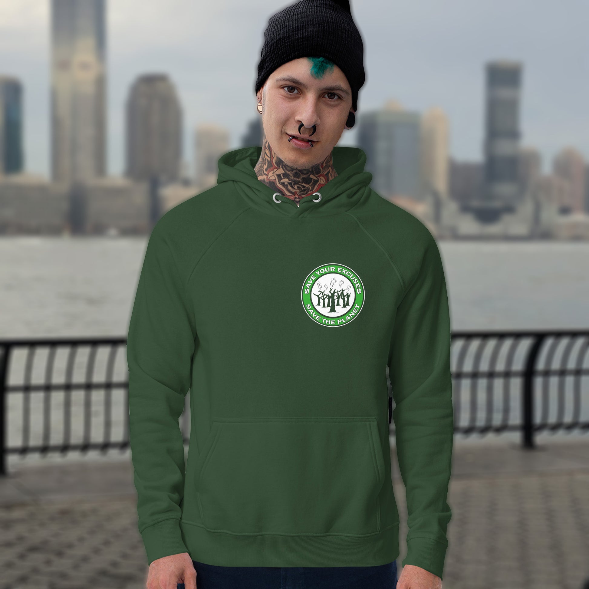 Person wearing a bottle green hoodie with a logo, standing in front of a city skyline. A save the planet t-shirt that promotes social awareness of environmental issues. It's time to stop making poor excuses for why we haven't got around to saving our planet yet. Comfortable and practical. It's extra soft and has a convenient front pouch pocket. Made from organic cotton and recycled polyester, this environmental awareness hoodie is a great eco-friendly choice.