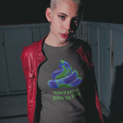 A short haired woman in a red jacket, wearing an anthracite grey t-shirt featuring a graphic of a swirling poop emoji with a blue and green globe pattern, above the text 'DON'T LET IT TURN TO SHIT' in green.