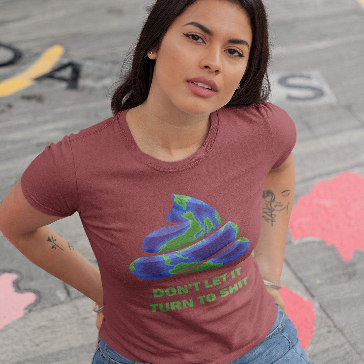 Woman wearing a burgundy t-shirt with a graphic design and text on a street background. A funny environmental t-shirt suggesting If we don't do something about our effect on the planet soon it'll all turn to shit. Save the planet satire. Made from 100% organic ring-spun cotton, this 'save our planet' t-shirt is unisex, high-quality, super comfy, and best of all, eco-friendly.