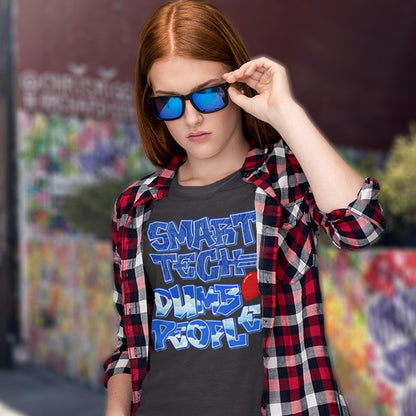 Person wearing a shirt with 'Smart Tech Dumbs People' text and plaid jacket, outdoors. This anti ai t shirt design suggests that the smarter the technology gets the dumber the people become. This contemporary design is ideal if you like t shirts for intellectuals and would rather exercise your mind than rely on machinery to do your thinking for you. Made from 100% organic ring-spun cotton, this non conformist t shirt is unisex, high-quality, super comfy, and best of all, eco-friendly.