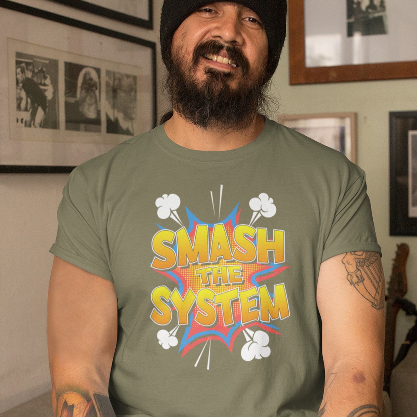 Man wearing a green t-shirt with 'SMASH THE SYSTEM' graphic design indoors. An anti government t shirt in a comic book style. A unique design for all you politically impatient comic book fans. Made from 100% organic ring-spun cotton, this non conformist t shirt is unisex, high-quality, super comfy, and best of all, eco-friendly.