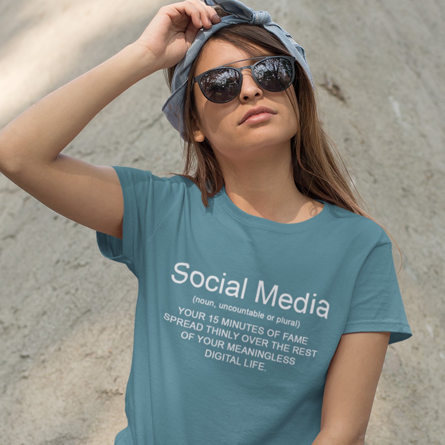 Woman wearing a stargazer t-shirt with a humorous definition of 'social media' text. An anti-social media t-shirt with a humorous definition. A unique t-shirt design for those who still have a real life and consider 'community' to be something you can touch and walk around. Made from 100% organic ring-spun cotton, this anti social media t-shirt is unisex, high-quality, super comfy, and best of all, eco-friendly.