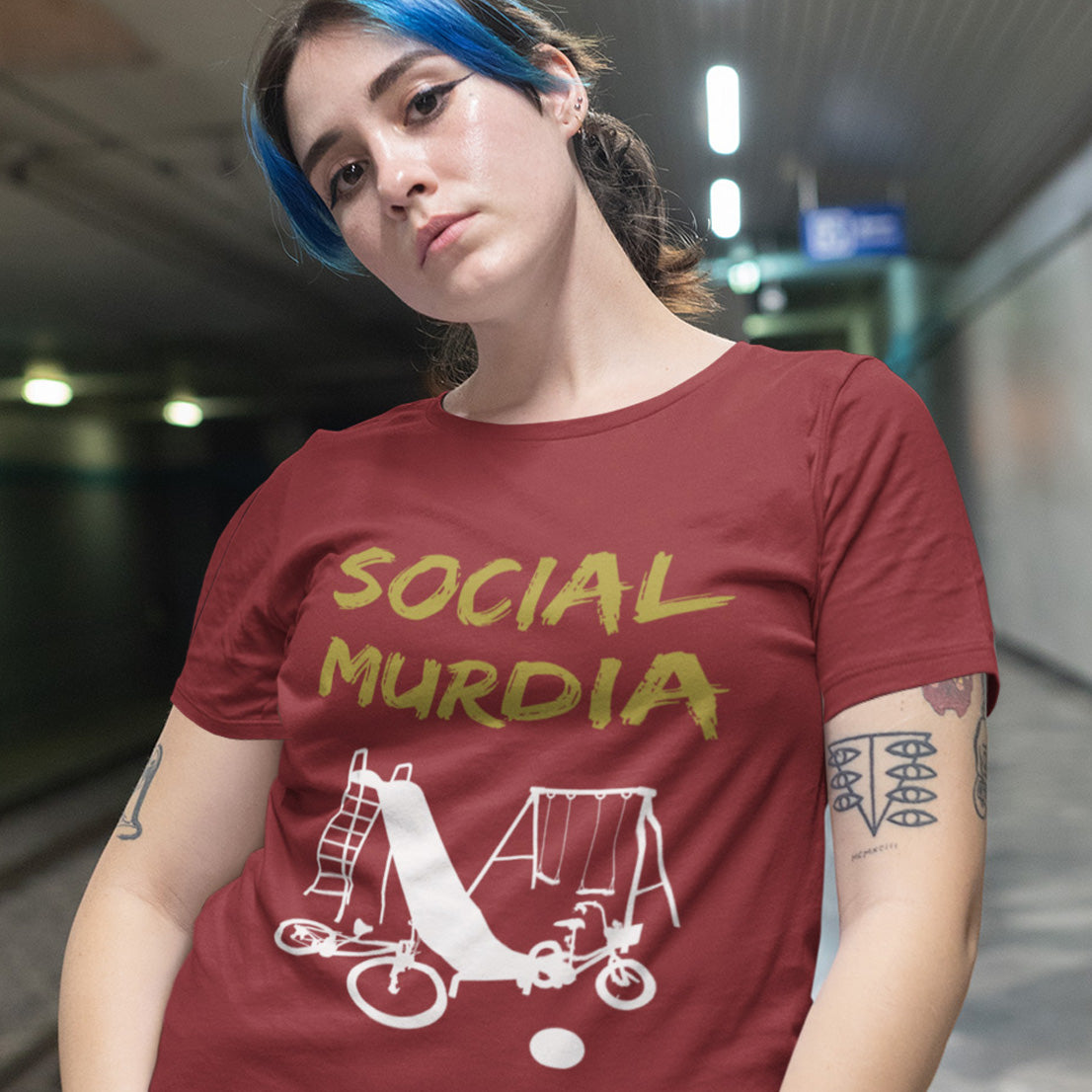 Person wearing a burgundy t-shirt with 'SOCIAL MURDIA' text and graphic design. This anti mobile phone abuse t shirt promoting social awareness of the effect of social media on our children. A unique design depicting how social media is probably murdering our society and leaving our playgrounds empty. Made from 100% organic ring-spun cotton, this anti social media t shirt is unisex, high-quality, super comfy, and best of all, eco-friendly.