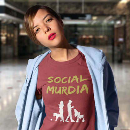 Person wearing a t-shirt with 'SOCIAL MURDIA' text and graphic design. An anti-social media t-shirt arguing against the abuse of social media and mobile phones. The main aim of social media is to connect people, but it doesn't look like that from street level. This anti-mobile phone design suggests society is actually being murdered by media on mobiles. Made from 100% organic ring-spun cotton, this social awareness t-shirt is unisex, high-quality, super comfy, and best of all, eco-friendly.