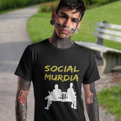 Person wearing a black t-shirt with 'SOCIAL MURDIA' text and graphic outdoors. An anti-social media t-shirt arguing against the abuse of social media and mobile phones.  This anti-mobile phone design suggests society is actually being murdered by media on mobiles. Made from 100% organic ring-spun cotton, this anti-social media t-shirt is unisex, high-quality, super comfy, and best of all, eco-friendly.