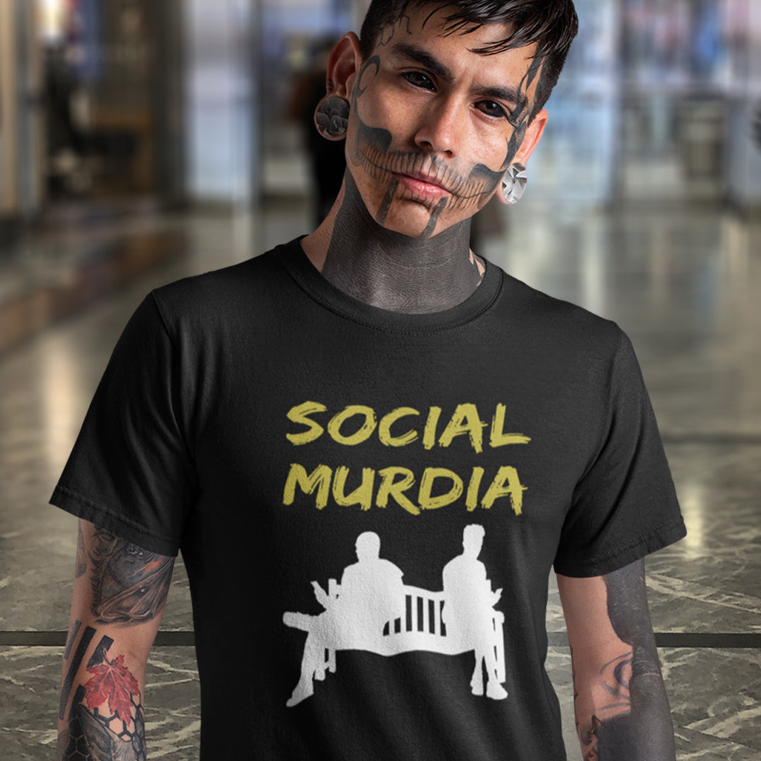 Person wearing a black t-shirt with 'SOCIAL MURDIA' text. An anti mobile phone abuse t shirt arguing against the abuse of social media and mobile phones. The main aim of social media is to connect people, but it doesn't look like that from street level. This anti-mobile phone design suggests society is actually being murdered by media on mobiles. Made from 100% organic ring-spun cotton, this anti social media t shirt is unisex, high-quality, super comfy, and best of all, eco-friendly.