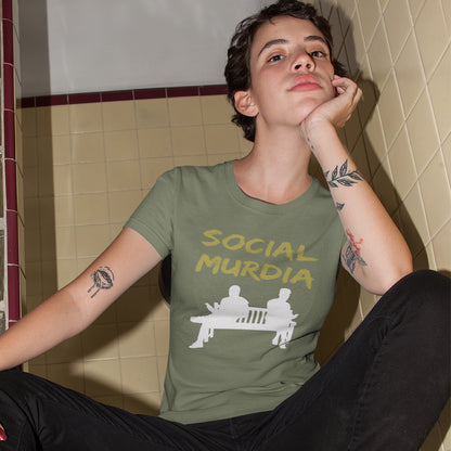 Person wearing a green t-shirt with 'SOCIAL MURDIA' text. An anti mobile phone abuse t shirt arguing against the abuse of social media and mobile phones. The main aim of social media is to connect people, but it doesn't look like that from street level. This anti-mobile phone design suggests society is actually being murdered by media on mobiles. Made from 100% organic ring-spun cotton, this anti social media t shirt is unisex, high-quality, super comfy, and best of all, eco-friendly.