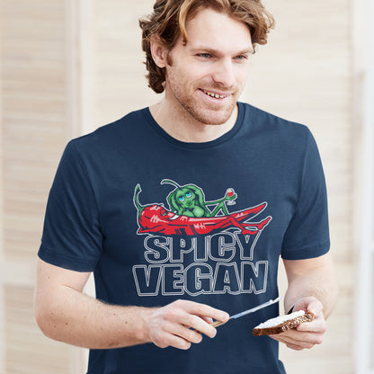 Man wearing a navy blue t-shirt with 'Spicy Vegan' graphic design. A plant based vegan t-shirt design for all you chilli loving spicy vegans out there. Spicy up your wardrobe with this unique funny plant based t-shirt, Made from 100% organic ring-spun cotton, this funny vegan t-shirt is unisex, high-quality, super comfy, and best of all, eco-friendly.