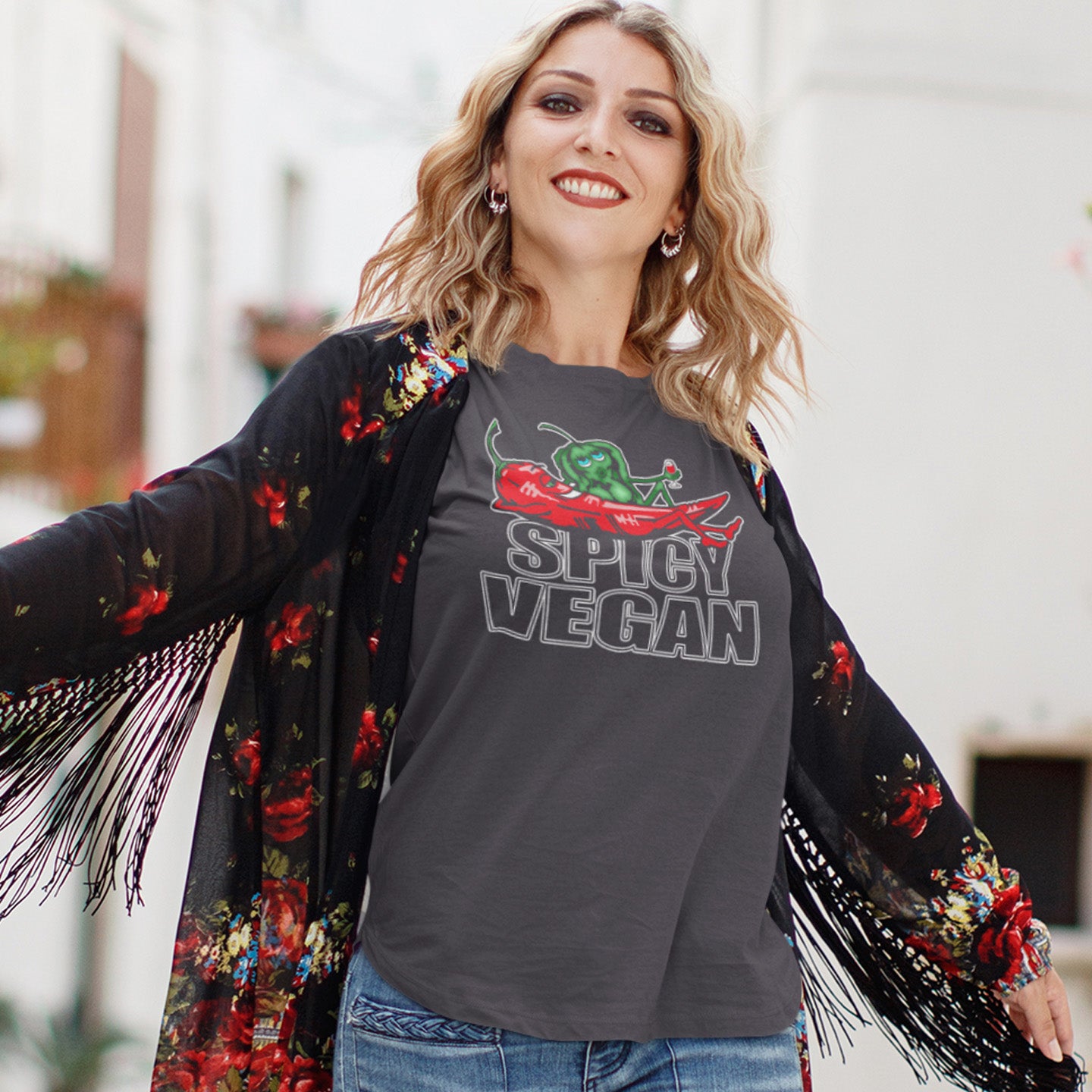 Woman wearing a 'Spicy Vegan' t-shirt with a floral kimono. A plant based vegan t-shirt design for all you chilli loving spicy vegans out there. Spicy up your wardrobe with this unique funny plant based t-shirt, Made from 100% organic ring-spun cotton, this funny vegan t-shirt is unisex, high-quality, super comfy, and best of all, eco-friendly.